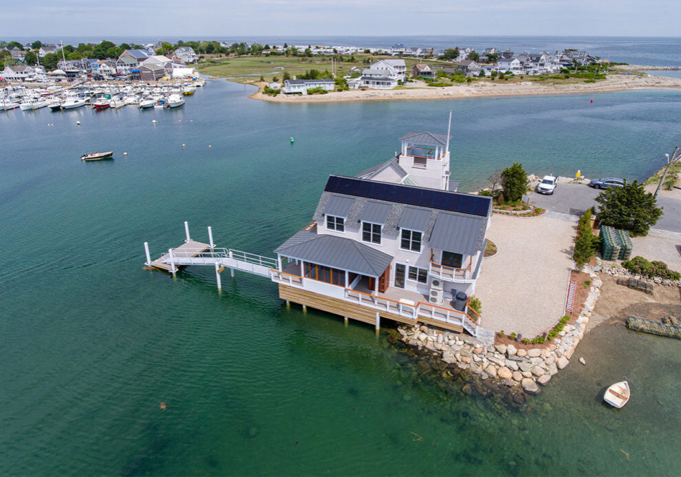Home with large dock at the mouth of a river in Marshfield, mA