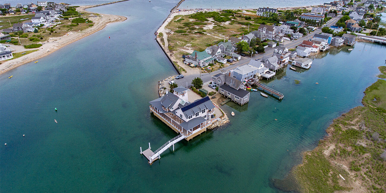Drone photo of home with views of harbor and breakwater in Marshfield, MA